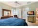 Inviting bedroom features a ceiling fan, large dresser, and bright natural light at 25221 Quail Croft Pl, Leesburg, FL 34748