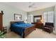 Charming bedroom boasts a ceiling fan, a full bed set, and plush carpeting at 25221 Quail Croft Pl, Leesburg, FL 34748