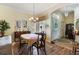 Traditional dining room with chandelier, wood floors and lots of natural light at 25221 Quail Croft Pl, Leesburg, FL 34748