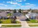 Well-maintained single-story home with lush landscaping, manicured lawn, and brick-paved driveway at 25221 Quail Croft Pl, Leesburg, FL 34748