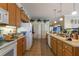 Spacious kitchen features tile floors, wooden cabinets, modern appliances, and natural light at 25221 Quail Croft Pl, Leesburg, FL 34748