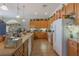Bright kitchen features tile floors, wood cabinets, modern appliances, and a large window at 25221 Quail Croft Pl, Leesburg, FL 34748