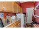 Well-lit laundry room with washer, dryer, storage cabinets, and sink at 25221 Quail Croft Pl, Leesburg, FL 34748