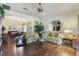 Open concept living room with hardwood floors and lots of natural light at 25221 Quail Croft Pl, Leesburg, FL 34748