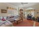 Bright living room featuring a large window, built-in shelves, and comfortable seating at 25221 Quail Croft Pl, Leesburg, FL 34748