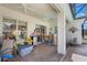 Covered patio with outdoor ceiling fans, furniture, and slider doors leading inside at 25221 Quail Croft Pl, Leesburg, FL 34748