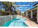 Screened-in backyard pool features tile surround, mature landscaping, and lounge seating at 25221 Quail Croft Pl, Leesburg, FL 34748