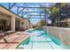 Screened-in backyard pool features tile surround, mature landscaping, and lounge seating at 25221 Quail Croft Pl, Leesburg, FL 34748