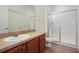 Bright bathroom with a large vanity, a toilet, and glass shower at 2604 Grand Central Pkwy # 12, Orlando, FL 32839