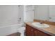 Bathroom featuring a single vanity, toilet, shower and tub combination with white tile at 2604 Grand Central Pkwy # 12, Orlando, FL 32839