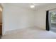 Large, bright carpeted bedroom with a ceiling fan and access to a balcony at 2604 Grand Central Pkwy # 12, Orlando, FL 32839