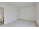 Spacious bedroom with neutral carpet and en suite bathroom through the doorway at 2604 Grand Central Pkwy # 12, Orlando, FL 32839