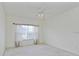 Bright bedroom with a large window with curtains at 2604 Grand Central Pkwy # 12, Orlando, FL 32839