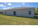 View of the home's backyard, with freshly cut lawn and sliding glass door at 2765 Sw 140Th Pl, Ocala, FL 34473