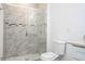 Bathroom with a tiled shower with glass door and a toilet with water saving tag at 2765 Sw 140Th Pl, Ocala, FL 34473