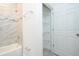 Bathroom featuring a tub with marble-style tile surround and glass mosaic accents with a shower at 2765 Sw 140Th Pl, Ocala, FL 34473