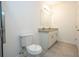 Bright bathroom featuring a dual granite vanity, toilet, and modern fixtures at 2765 Sw 140Th Pl, Ocala, FL 34473