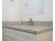 Close-up of bathroom vanity with granite countertop, modern faucet, and gray cabinets at 2765 Sw 140Th Pl, Ocala, FL 34473
