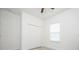 Bright bedroom with white walls, ceiling fan and a window with white blinds, and bi-fold closet doors at 2765 Sw 140Th Pl, Ocala, FL 34473