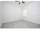 Bright bedroom with white walls, ceiling fan and a window with white blinds, featuring gray tile floors throughout at 2765 Sw 140Th Pl, Ocala, FL 34473