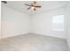 An airy bedroom featuring neutral tile flooring and natural light from a large window at 2765 Sw 140Th Pl, Ocala, FL 34473