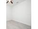 Bright bedroom with white walls, ceiling fan, and a window, featuring gray tile floors throughout at 2765 Sw 140Th Pl, Ocala, FL 34473