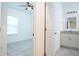Bedroom view through door to bathroom, featuring tile flooring and a ceiling fan at 2765 Sw 140Th Pl, Ocala, FL 34473