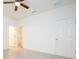 Bright bedroom with neutral tile, ceiling fan, and doors to closet and adjacent rooms at 2765 Sw 140Th Pl, Ocala, FL 34473