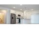 Well-equipped kitchen showcasing white cabinetry, stainless steel appliances, and a granite countertop island at 2765 Sw 140Th Pl, Ocala, FL 34473