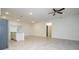 Spacious open-concept kitchen and living area with white cabinets, granite countertops, and stainless steel appliances at 2765 Sw 140Th Pl, Ocala, FL 34473