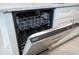 New stainless steel dishwasher with a granite countertop and white cabinets at 2765 Sw 140Th Pl, Ocala, FL 34473