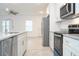 Bright kitchen featuring stainless steel appliances, granite countertops, and white cabinetry at 2765 Sw 140Th Pl, Ocala, FL 34473