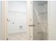 Laundry room with a door that opens to wire shelving at 2765 Sw 140Th Pl, Ocala, FL 34473