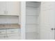 Pantry shelves in kitchen with white cabinets and gray granite countertops at 2765 Sw 140Th Pl, Ocala, FL 34473