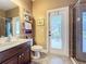 Bathroom featuring walk-in shower, built in linen shelves, and updated fixtures at 2805 Ponkan Meadow Dr, Apopka, FL 32712