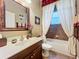 Bathroom features a large vanity, mirror, and soaking tub with shower curtain at 2805 Ponkan Meadow Dr, Apopka, FL 32712