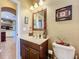 Bathroom with wood cabinet and sink, with framed wall mirror, and modern fixtures at 2805 Ponkan Meadow Dr, Apopka, FL 32712