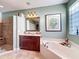 Bathroom featuring a walk-in shower, soaking tub, and cherry cabinets at 2805 Ponkan Meadow Dr, Apopka, FL 32712