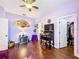 Charming bedroom featuring hardwood floors, a ceiling fan, and an adjacent walk-in closet at 2805 Ponkan Meadow Dr, Apopka, FL 32712