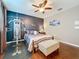 This bedroom boasts wood floors, a ceiling fan, and an exercise machine at 2805 Ponkan Meadow Dr, Apopka, FL 32712
