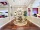 Bright dining room featuring hardwood floors, a chandelier, and tasteful decor for intimate gatherings at 2805 Ponkan Meadow Dr, Apopka, FL 32712