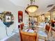 A formal dining area features a glass table and seating adjacent to an open-concept kitchen at 2805 Ponkan Meadow Dr, Apopka, FL 32712