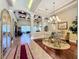 Open-concept dining area with coffered ceilings, chandelier, and hardwood floors for elegant entertaining at 2805 Ponkan Meadow Dr, Apopka, FL 32712