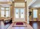 Inviting foyer with tile and hardwood flooring, double doors, and views into adjacent living spaces at 2805 Ponkan Meadow Dr, Apopka, FL 32712