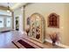 Elegant foyer with tile flooring, display cabinet, and ample natural light from the front door at 2805 Ponkan Meadow Dr, Apopka, FL 32712