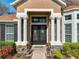 Inviting front entrance with decorative columns, stone accents, and a double door entry at 2805 Ponkan Meadow Dr, Apopka, FL 32712