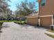 Large two-car garage with brick-paved driveway and manicured landscaping at 2805 Ponkan Meadow Dr, Apopka, FL 32712