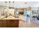 Bright kitchen with an island, stainless steel appliances, and access to the living area at 2805 Ponkan Meadow Dr, Apopka, FL 32712