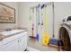 Functional laundry room with a utility sink, storage cabinets, and modern appliances at 2805 Ponkan Meadow Dr, Apopka, FL 32712