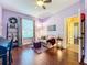Bright living room featuring hardwood floors, a ceiling fan, and large window at 2805 Ponkan Meadow Dr, Apopka, FL 32712